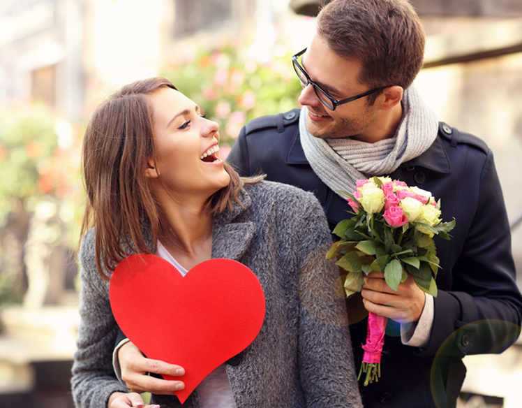 Picture of young man surprising woman with flowers and heart