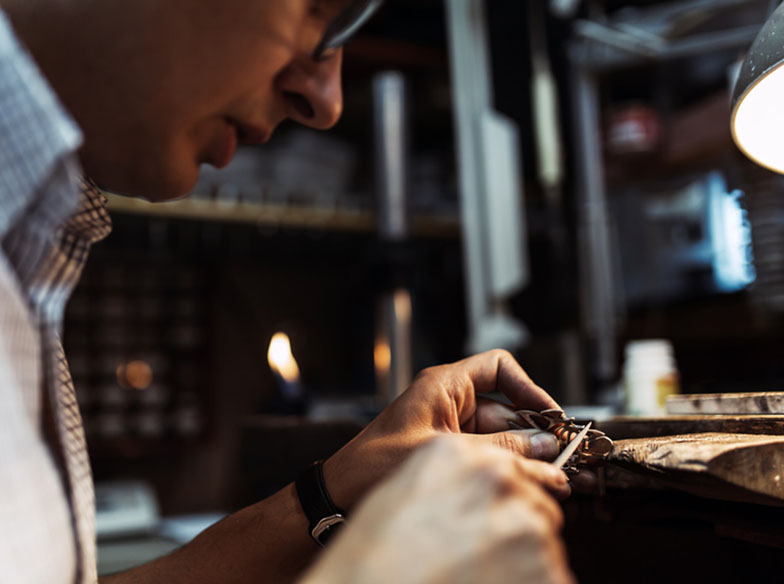 Goldsmith working and creating jewelry