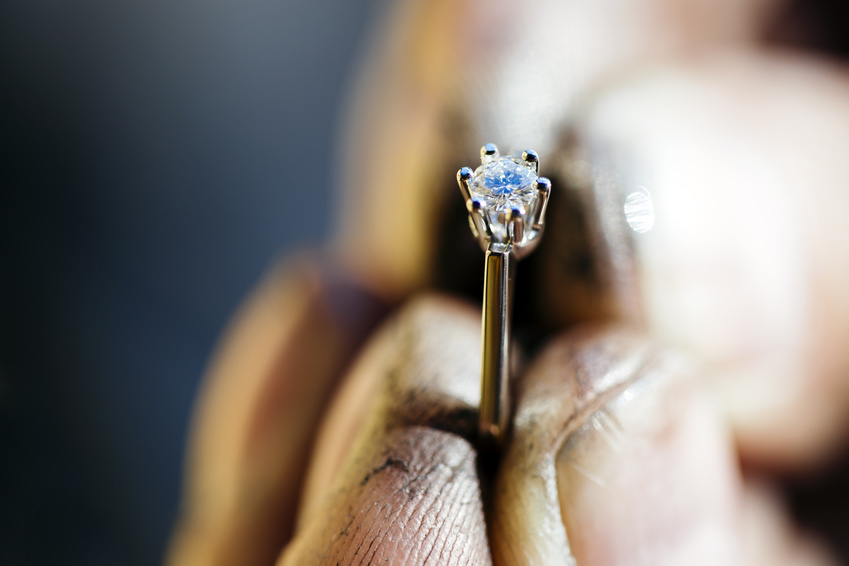 Ring held by jeweler after polishing it