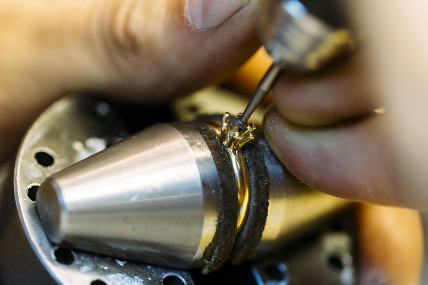 Jeweler working on a ring with precision tools