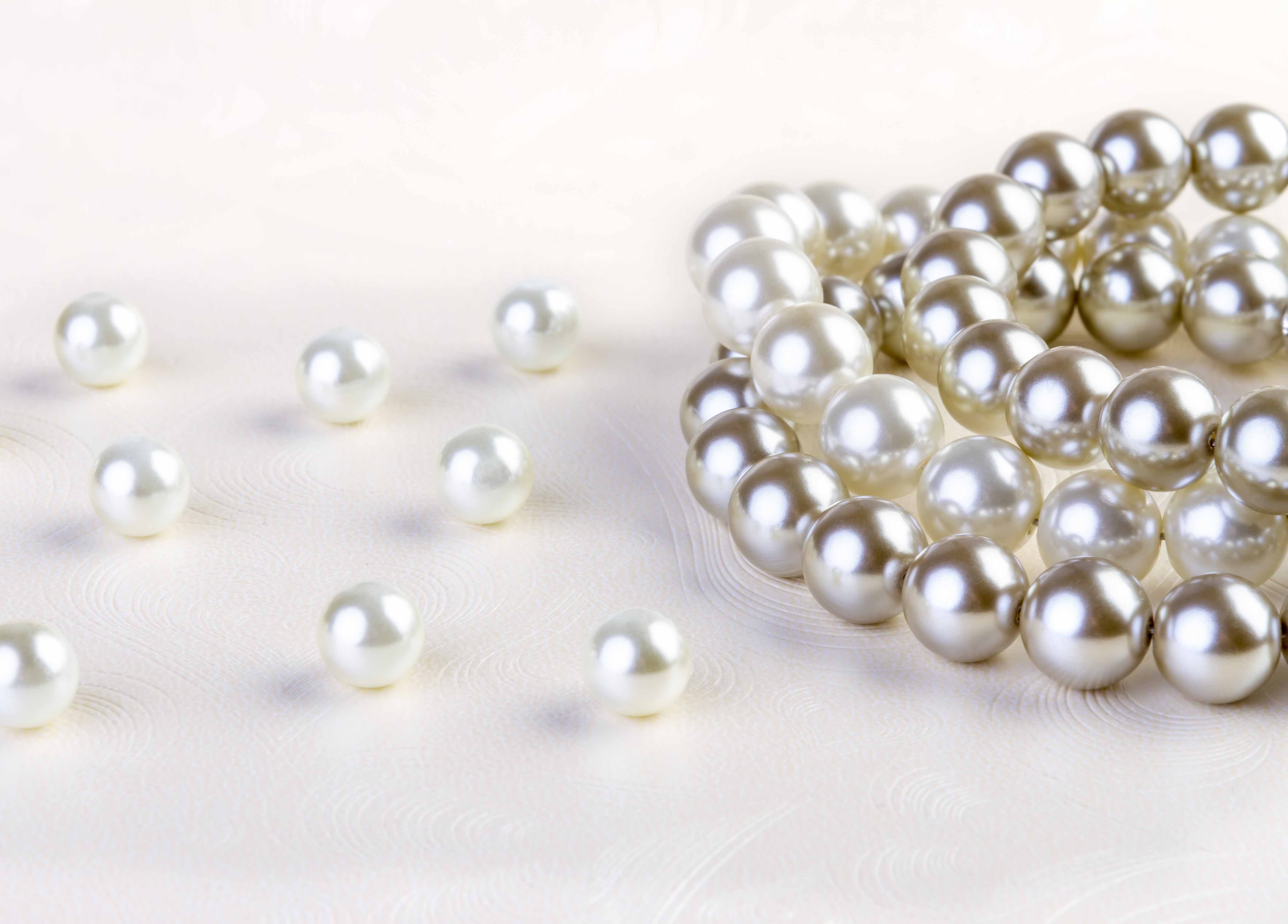 Silver and White pearls necklace on white paper background