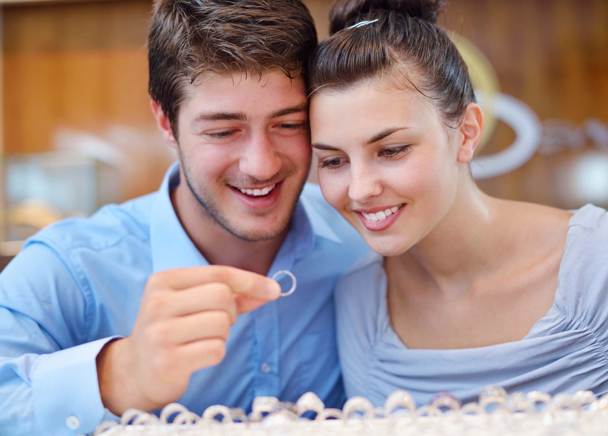 happy young romantic couple in love buy jewelry ring in luxury store