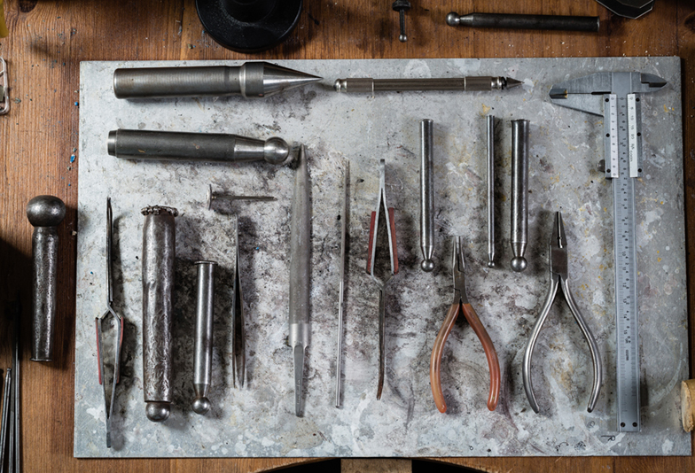 Working desk for craft jewelery making with professional tools.