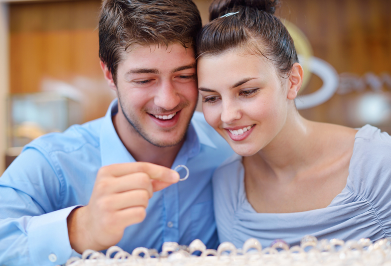happy young romantic couple in love buy jewelry ring in luxury store