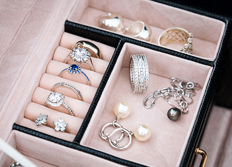 Jewelry box with white gold and silver rings, earrings and pendants with pearls. Collection of luxury jewelry