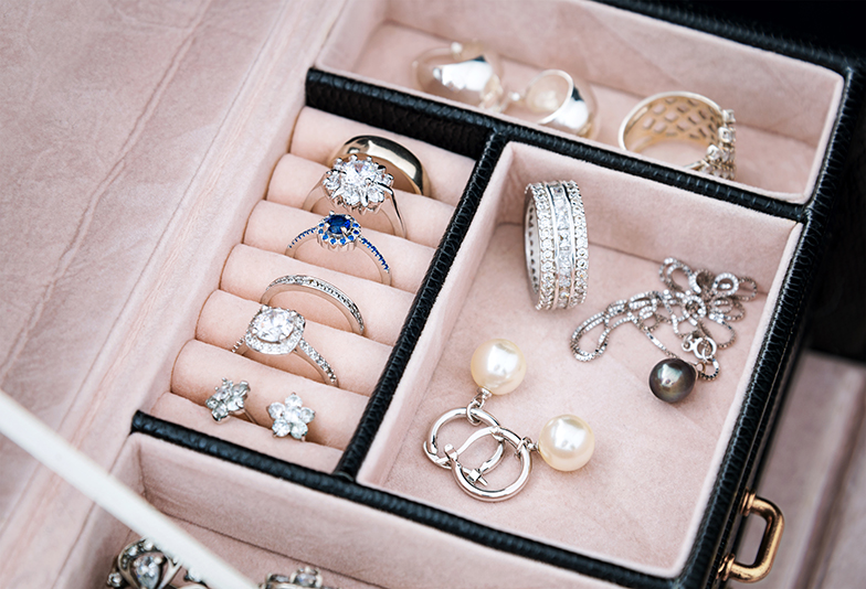 Jewelry box with white gold and silver rings, earrings and pendants with pearls. Collection of luxury jewelry