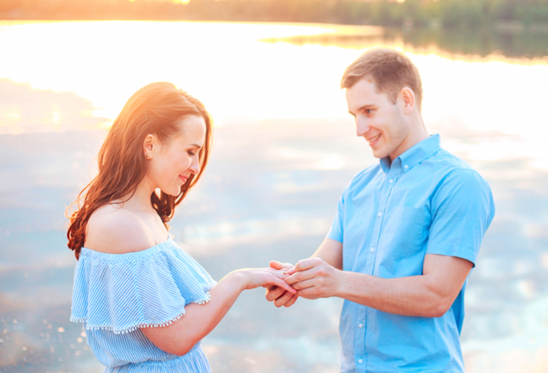 Marriage proposal on sunset . young man makes a proposal of betrothal to his girlfriend on the beach