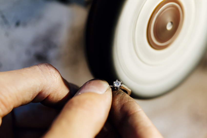 Jewelery polishing ring in workshop with adequate tools