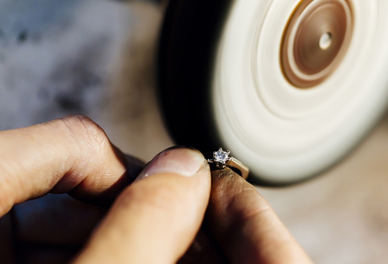 Jewelery polishing ring in workshop with adequate tools