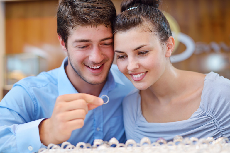 happy young romantic couple in love buy jewelry ring in luxury store