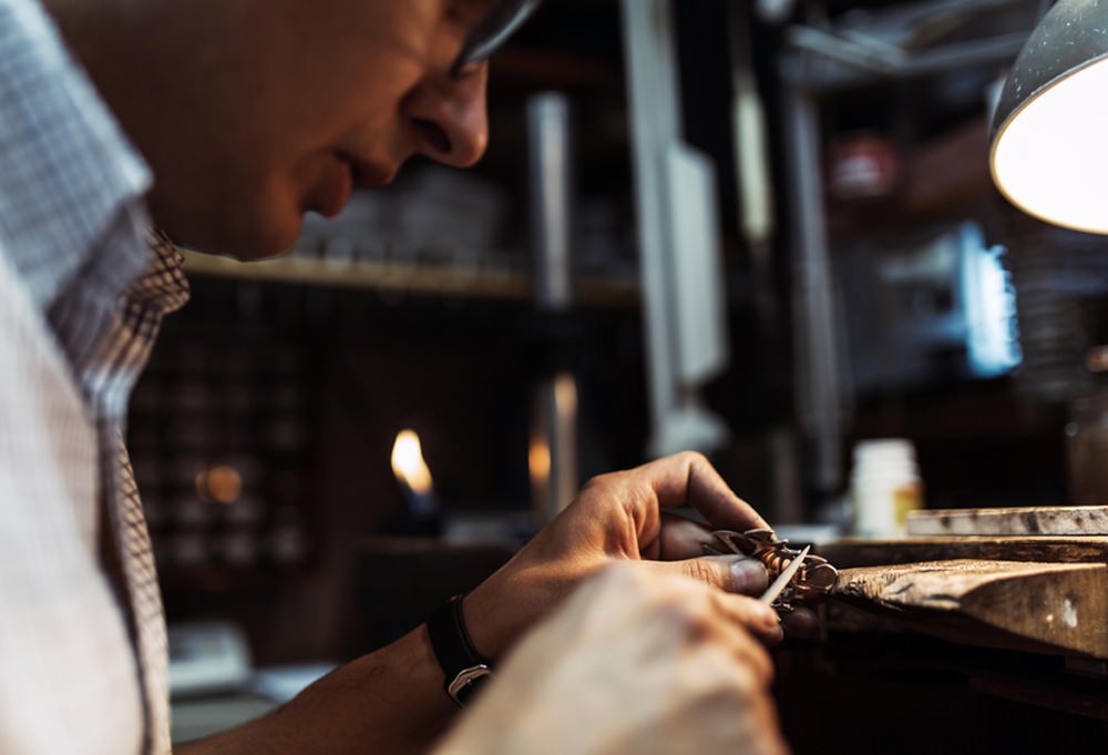 Goldsmith working and creating jewelry