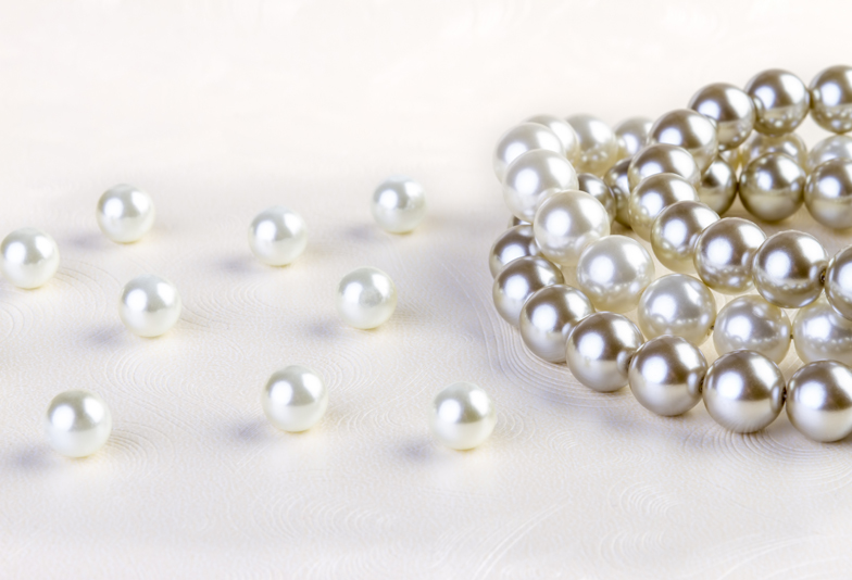 Silver and White pearls necklace on white paper background